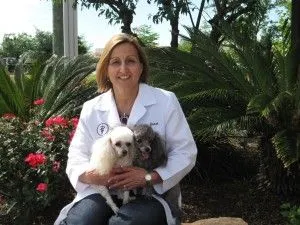 Dr. Quast sitting with 2 dogs